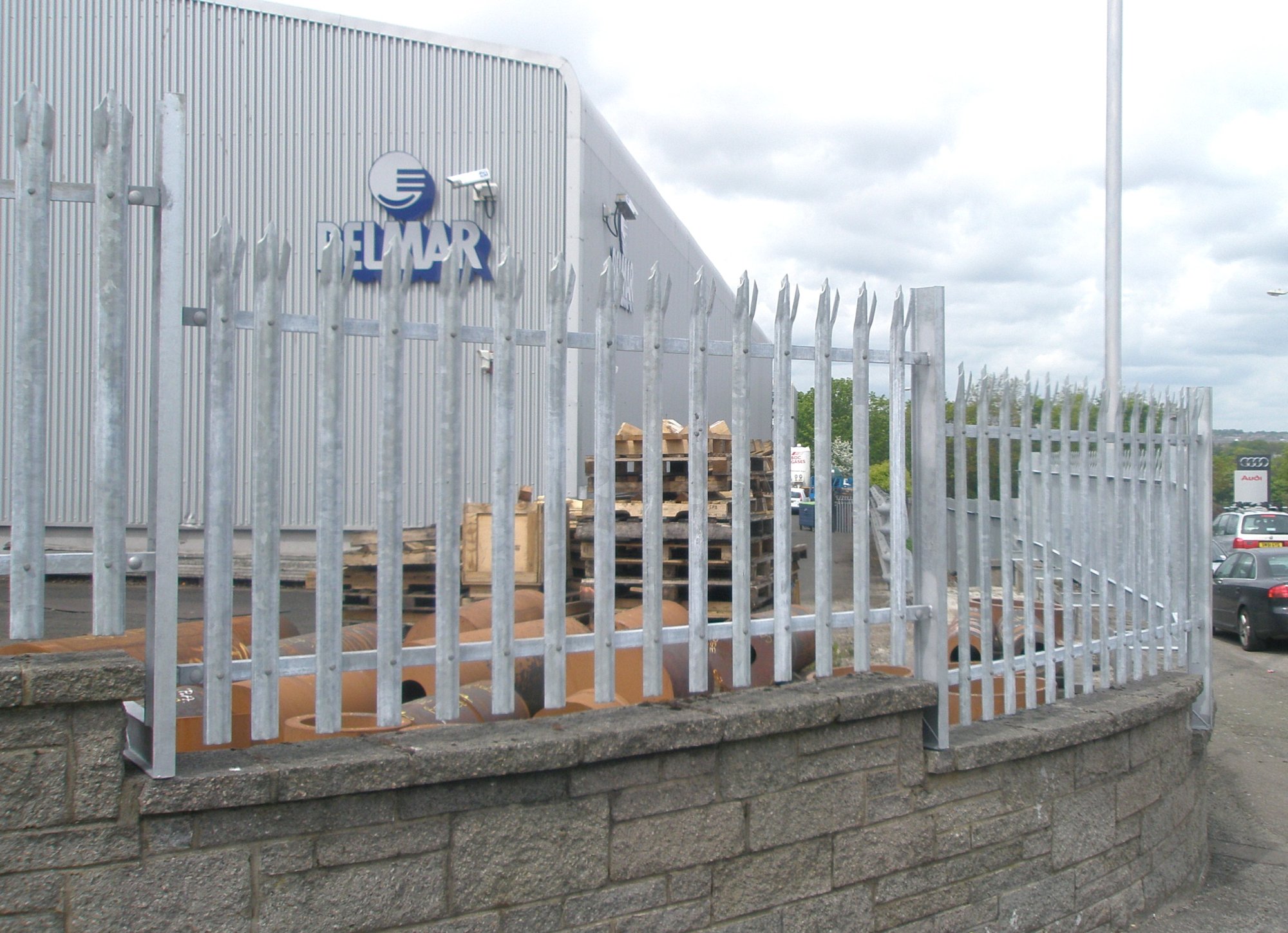 Palisade installed above a wall supported on bespoke cranked posts manufactured in our fabrication workshop.