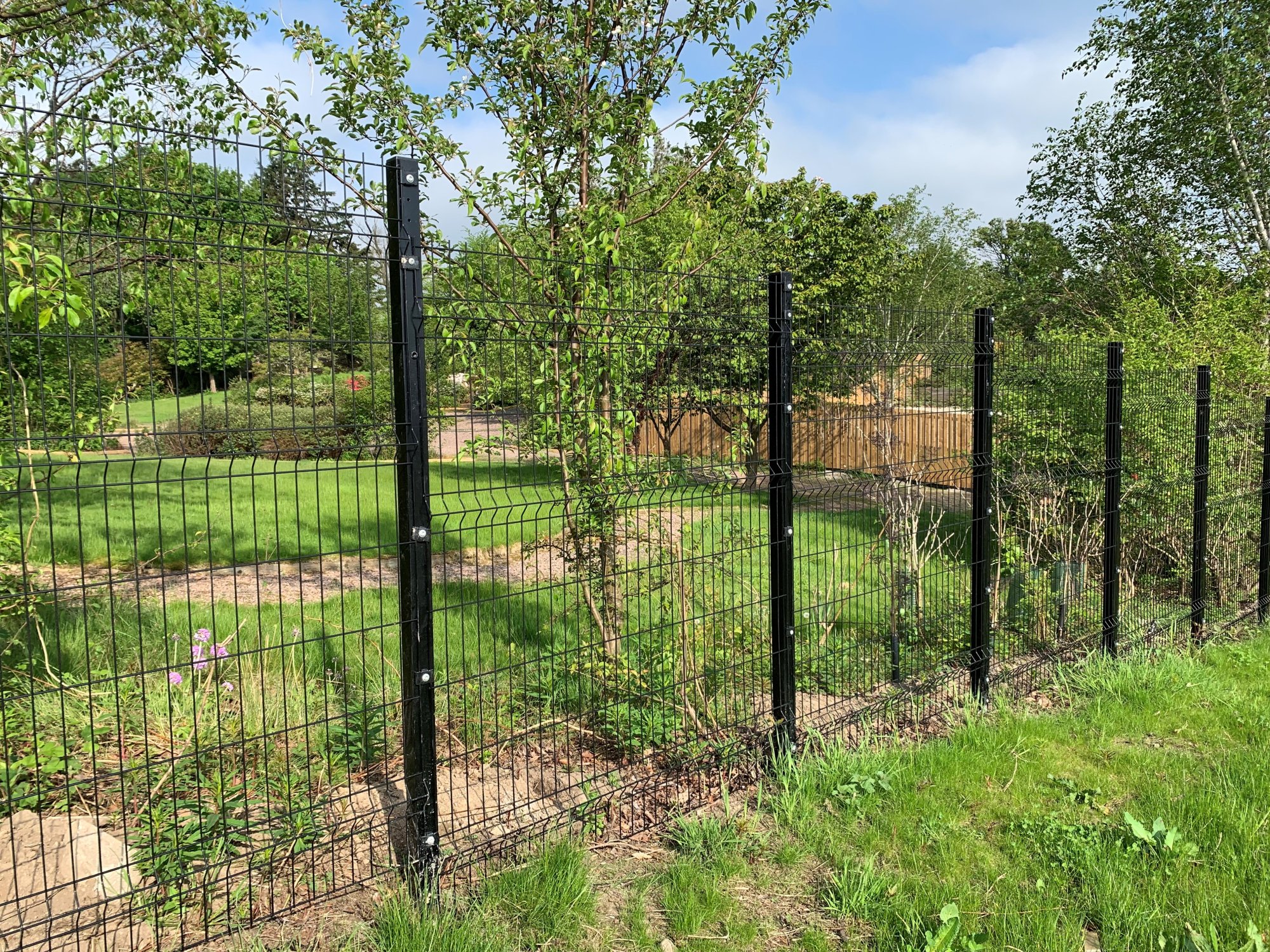 The posts on panel systems are set at reduced centres to accommodate sloping ground.