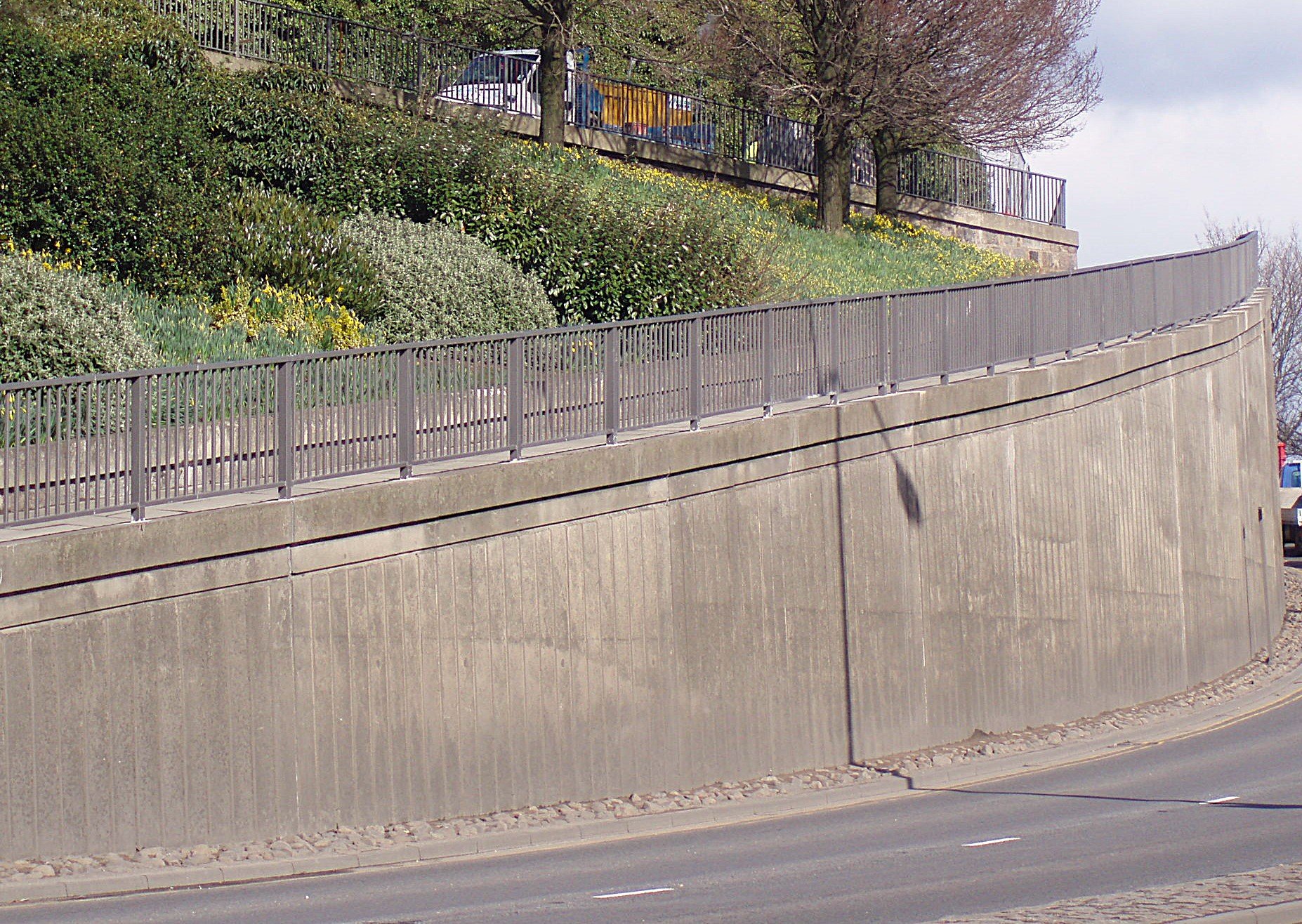 Pedestrian parapet railings fabricated and installed along a raised footpath.
