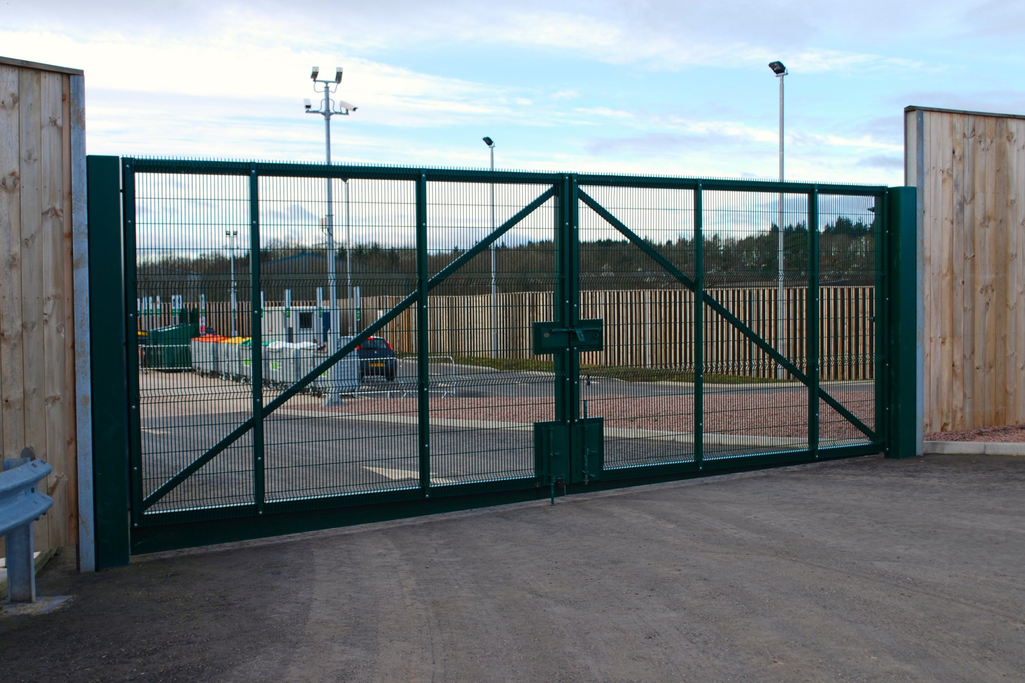 Double leaf gate fabricated in house and clad with Ultimate Extra profiled panels. Galvanised and polyester powder coated finish. Gate skirts fitted to reduce the below the gate when closed.