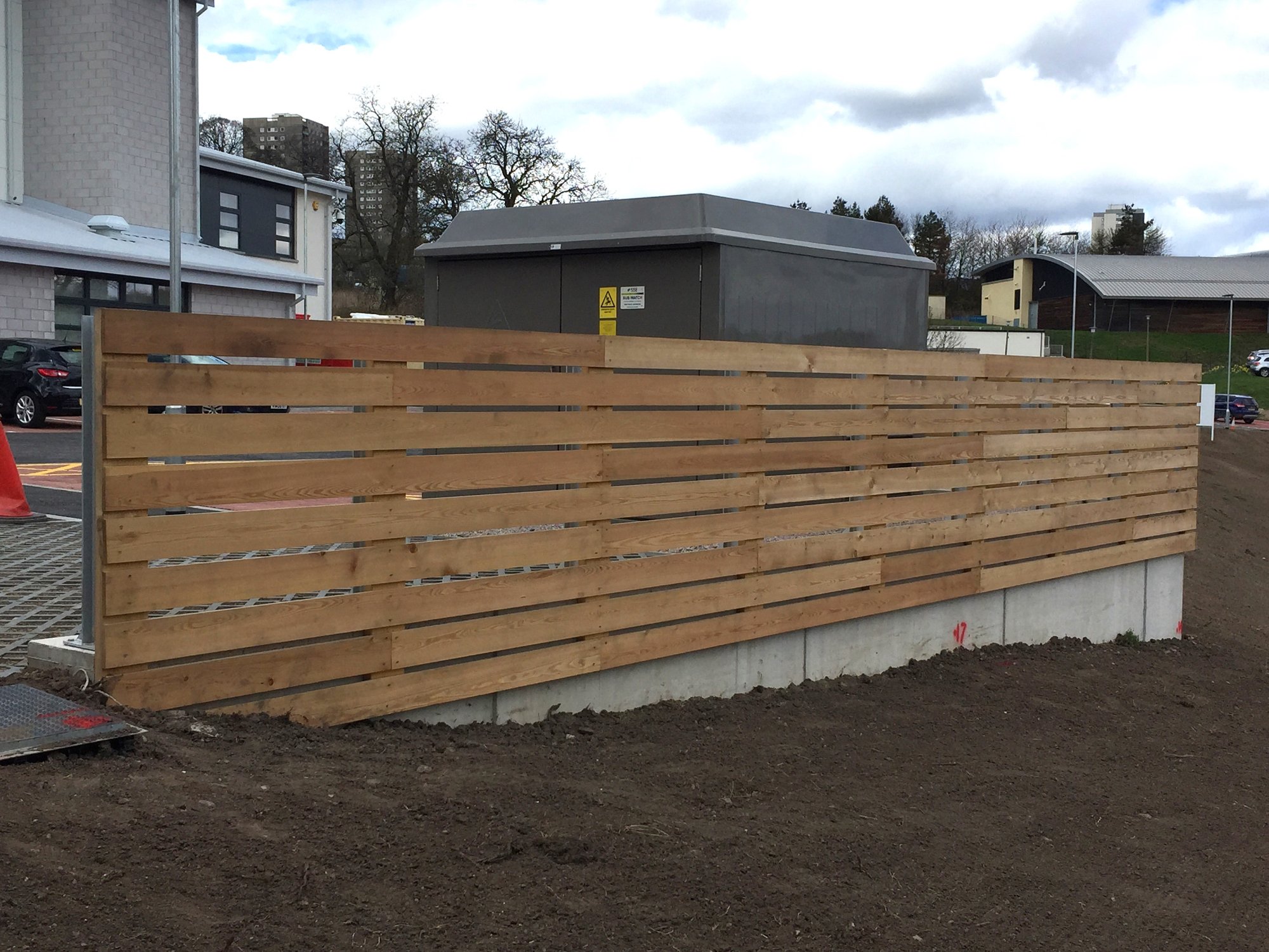 1200mm high fencing on galvanised UB posts baseplated and fixed to the concrete retaining wall.