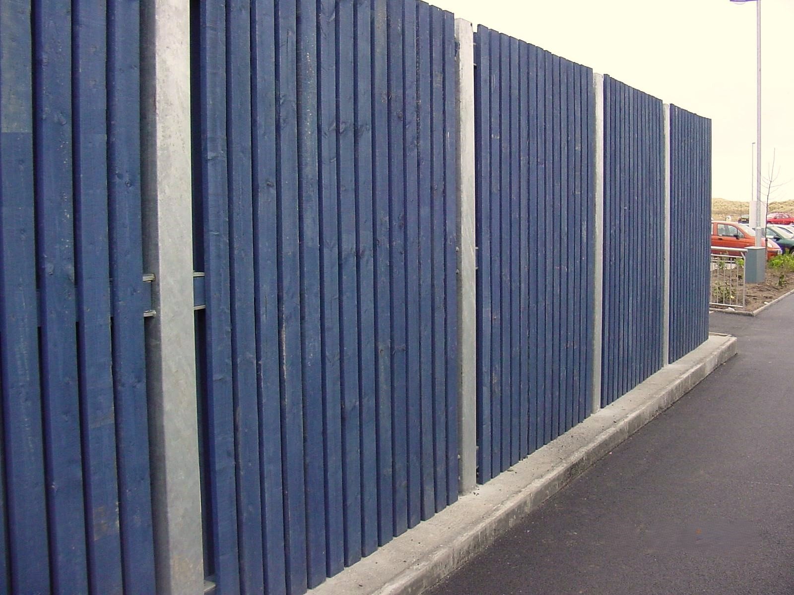 Blue stained timber panels fixed to galvanised SHS posts.