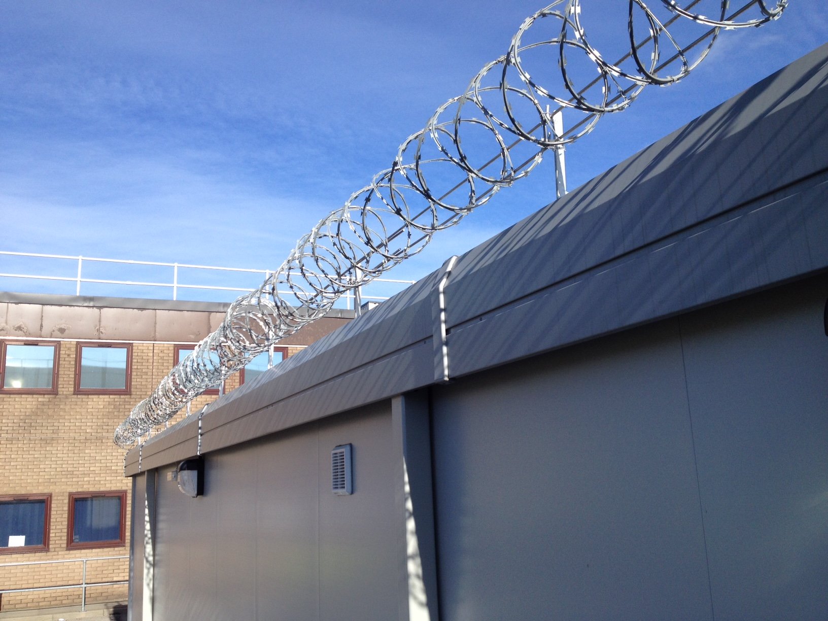 Concertina razor wire to secure a flat roof.