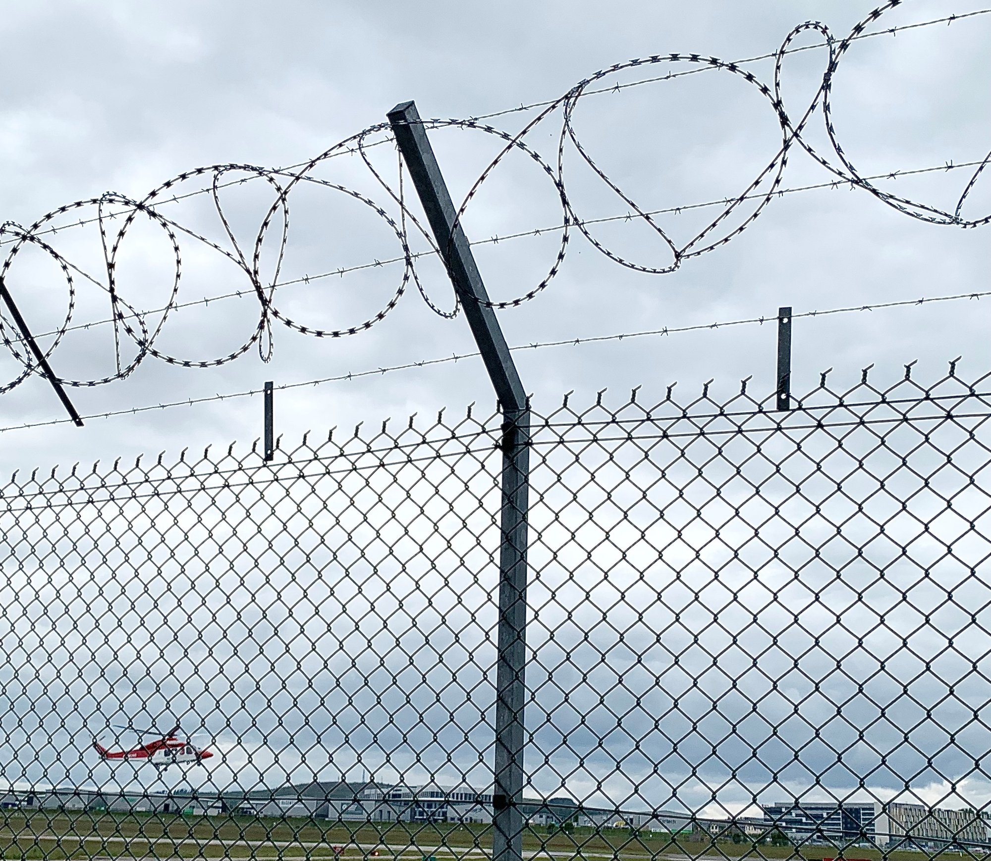 Concertina razor wire installed above a BS1722 Part 10 chainlink security fence.
